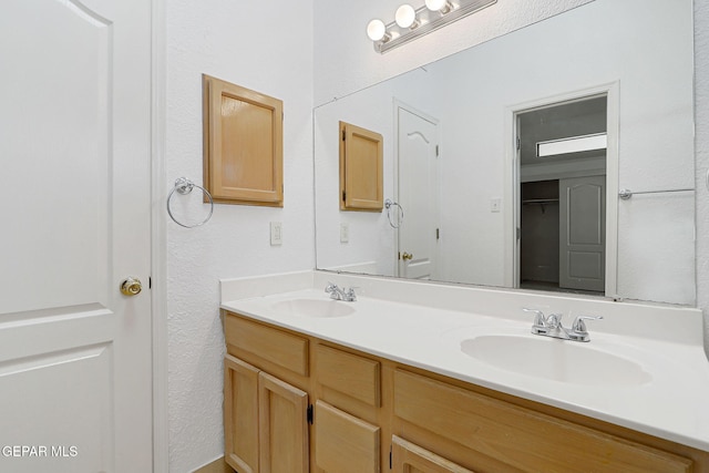 7145 Golden Hawk Dr, El Paso, TX 79912 - bathroom with double vanity and a textured wall
