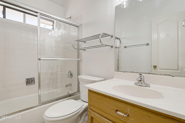 7145 Golden Hawk Dr, El Paso, TX 79912 - bathroom with toilet, vanity, shower / bath combination with glass door, and a textured wall