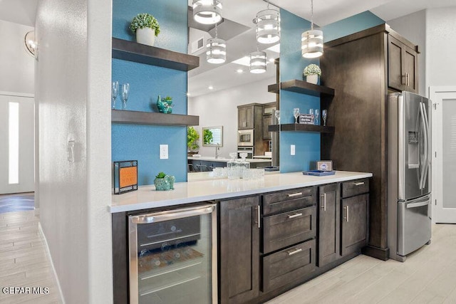 2212 Mike Price Dr, El Paso, TX 79938 - kitchen with open shelves, beverage cooler, appliances with stainless steel finishes, dark brown cabinets, and light wood-style flooring