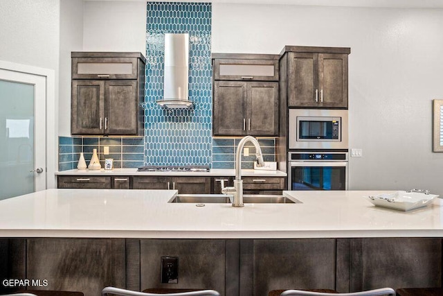2212 Mike Price Dr, El Paso, TX 79938 - kitchen featuring appliances with stainless steel finishes, extractor fan, dark brown cabinetry, tasteful backsplash, and light countertops