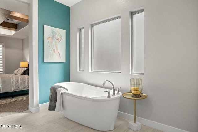 2212 Mike Price Dr, El Paso, TX 79938 - ensuite bathroom with a freestanding tub, wood finished floors, and beam ceiling