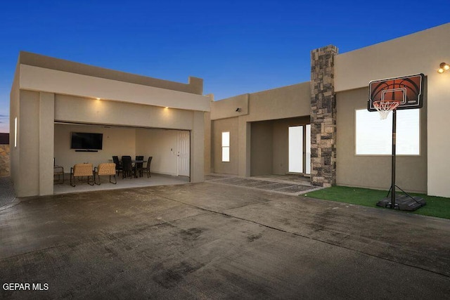 2212 Mike Price Dr, El Paso, TX 79938 - view of front facade with stucco siding, a patio area, outdoor dining space, and an attached garage