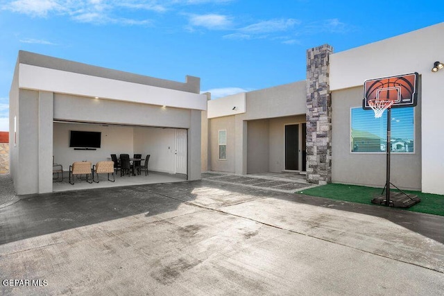 2212 Mike Price Dr, El Paso, TX 79938 - back of house featuring stucco siding, a patio area, outdoor dining area, and a garage