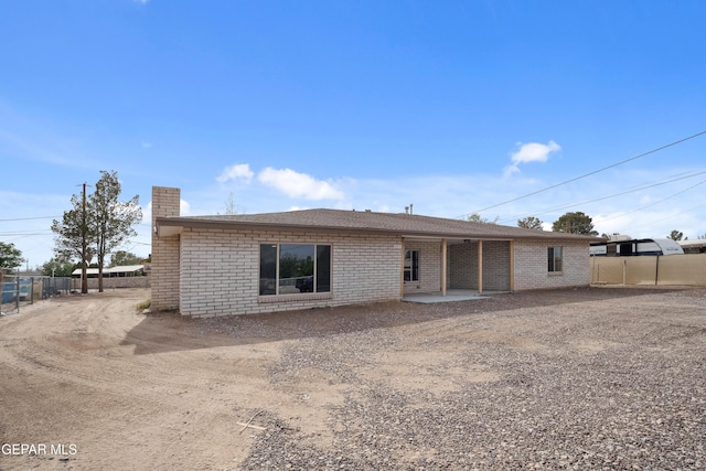 10950 Jo Way, Socorro, TX 79927 - rear view of house featuring a chimney and brick siding