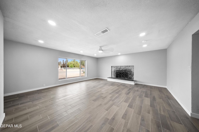 10950 Jo Way, Socorro, TX 79927 - unfurnished living room featuring wood finished floors, recessed lighting, a ceiling fan, baseboards, and a textured ceiling