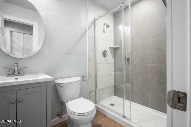 10950 Jo Way, Socorro, TX 79927 - bathroom featuring a stall shower, toilet, wood finished floors, and vanity