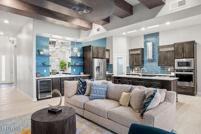 2228 Mike Price Dr, El Paso, TX 79938 - living area featuring beverage cooler, recessed lighting, light wood-style floors, and beamed ceiling