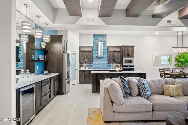 2228 Mike Price Dr, El Paso, TX 79938 - living room featuring beverage cooler and light wood-type flooring