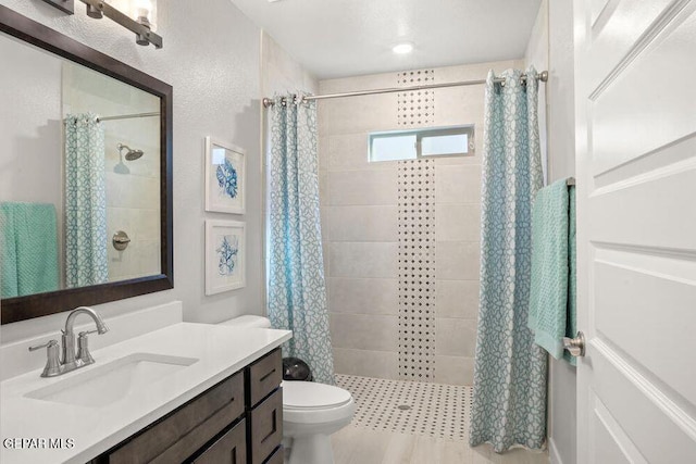 2228 Mike Price Dr, El Paso, TX 79938 - full bath featuring vanity, a tile shower, and wood finished floors