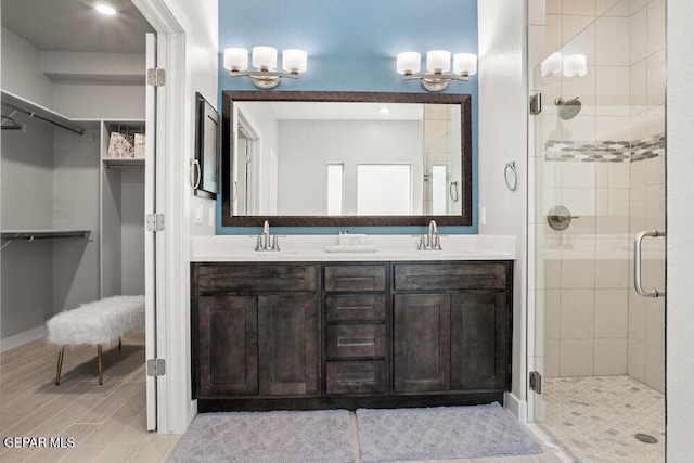 2228 Mike Price Dr, El Paso, TX 79938 - bathroom featuring a shower stall, double vanity, a walk in closet, and a chandelier