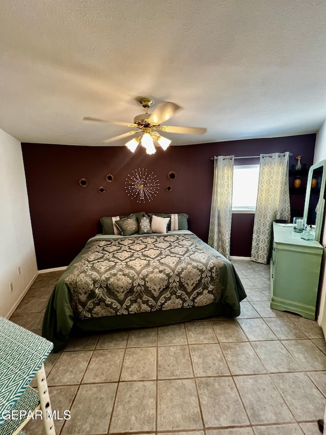16899 Old Butterfield Trl, El Paso, TX 79938 - bedroom with light tile patterned flooring, ceiling fan, and a textured ceiling