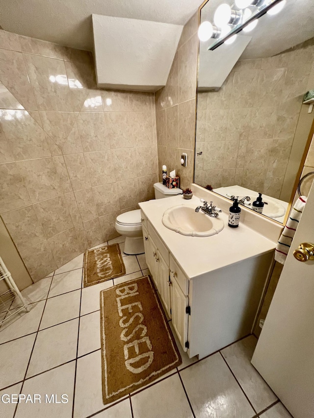 16899 Old Butterfield Trl, El Paso, TX 79938 - bathroom with tile patterned flooring, tile walls, and vanity