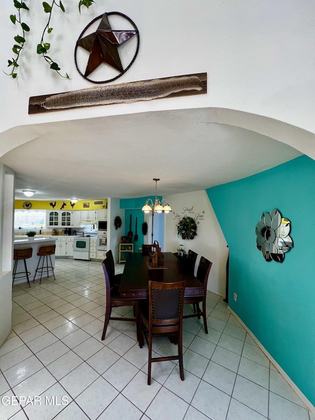 16899 Old Butterfield Trl, El Paso, TX 79938 - dining space featuring light tile patterned flooring and a chandelier