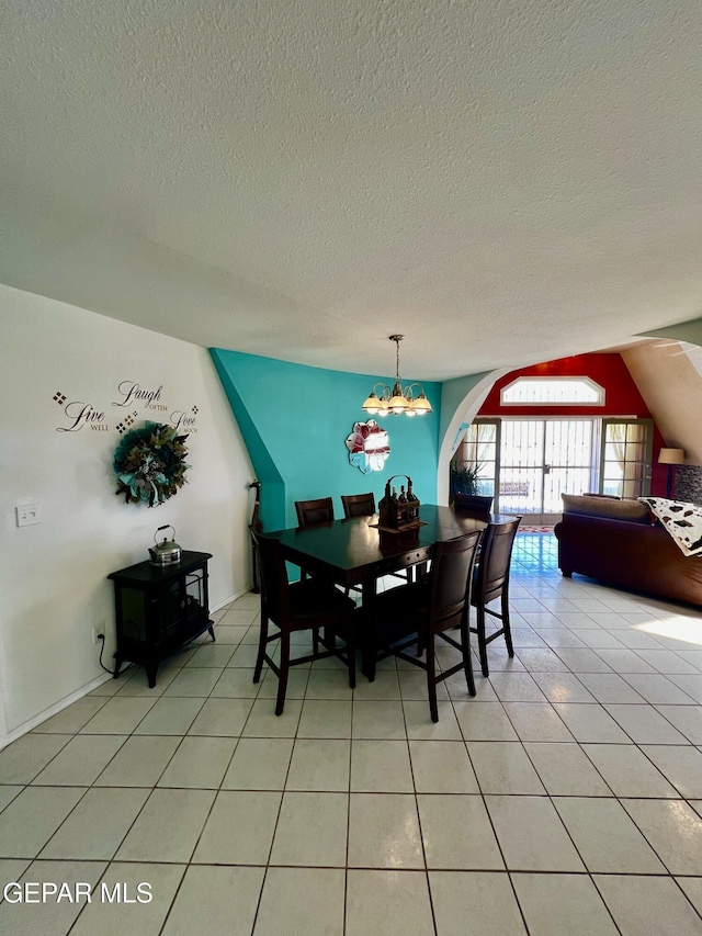 16899 Old Butterfield Trl, El Paso, TX 79938 - dining room featuring a textured ceiling, a chandelier, and light tile patterned flooring