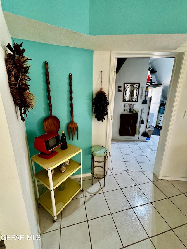16899 Old Butterfield Trl, El Paso, TX 79938 - hallway with tile patterned floors and baseboards