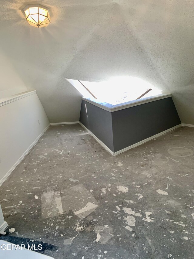 16899 Old Butterfield Trl, El Paso, TX 79938 - bonus room with a textured ceiling and vaulted ceiling