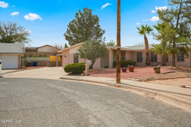 10601 Groverock Ct, El Paso, TX 79935 - view of front of house featuring brick siding, concrete driveway, and a garage
