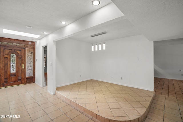 10601 Groverock Ct, El Paso, TX 79935 - entrance foyer featuring light tile patterned flooring, a textured ceiling, baseboards, and recessed lighting
