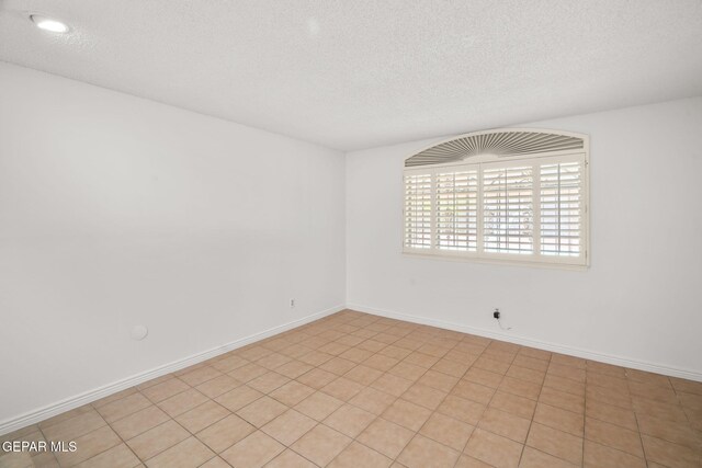10601 Groverock Ct, El Paso, TX 79935 - unfurnished room with a textured ceiling and baseboards