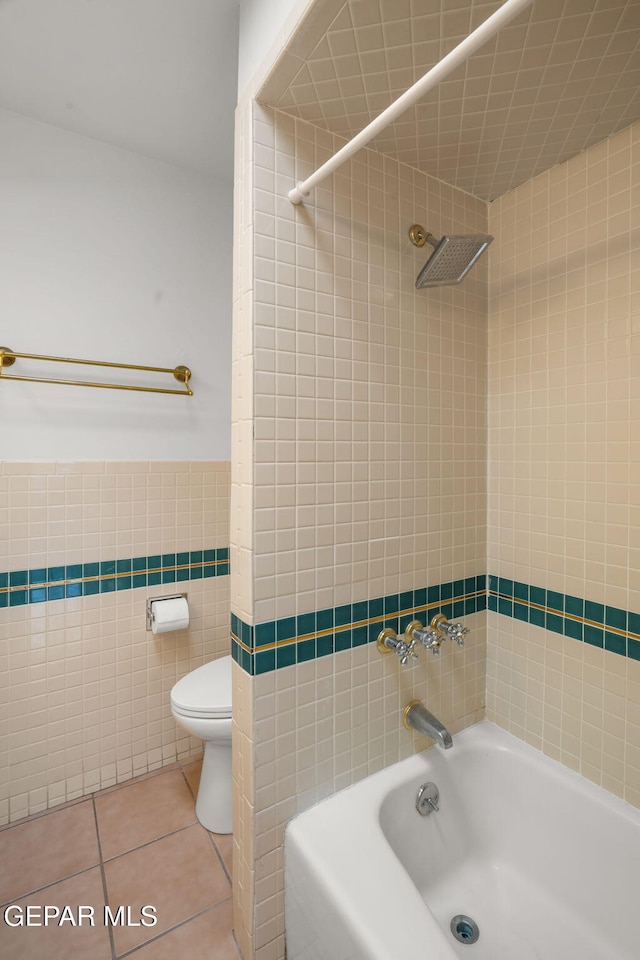 10601 Groverock Ct, El Paso, TX 79935 - full bath featuring tile walls, shower / bathtub combination, tile patterned flooring, and toilet