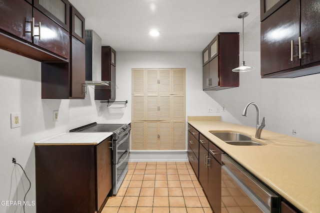 10601 Groverock Ct, El Paso, TX 79935 - kitchen with stainless steel appliances, a sink, wall chimney exhaust hood, light countertops, and light tile patterned floors