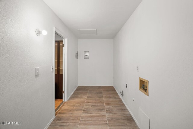 10601 Groverock Ct, El Paso, TX 79935 - laundry area featuring washer hookup, wood finished floors, attic access, hookup for an electric dryer, and hookup for a gas dryer