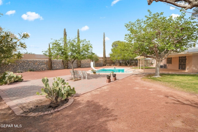 10601 Groverock Ct, El Paso, TX 79935 - view of swimming pool featuring a water slide, a patio area, and a fenced backyard