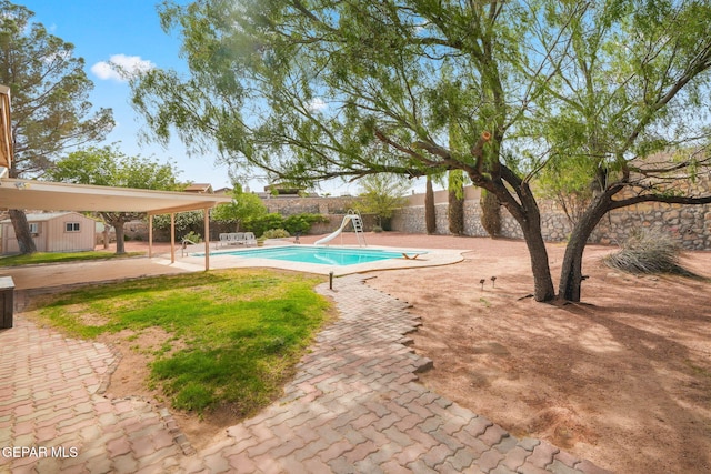 10601 Groverock Ct, El Paso, TX 79935 - view of swimming pool with a water slide, a fenced backyard, and a patio area