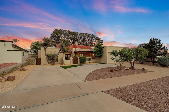 840 Tepic Dr, El Paso, TX 79912 - mediterranean / spanish-style house featuring driveway, stucco siding, and a gate