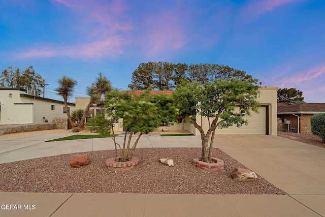 840 Tepic Dr, El Paso, TX 79912 - view of front of house with driveway, stucco siding, and a garage