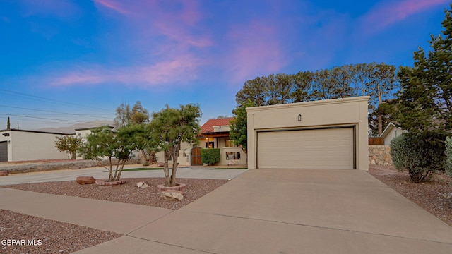 840 Tepic Dr, El Paso, TX 79912 - view of front facade with driveway, stucco siding, and a garage