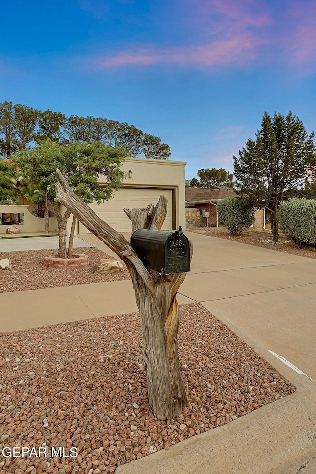 840 Tepic Dr, El Paso, TX 79912 - view of front facade with driveway, an attached garage, and stucco siding