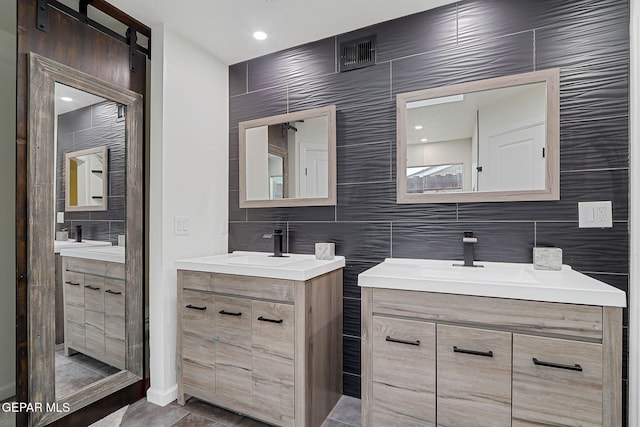 840 Tepic Dr, El Paso, TX 79912 - bathroom with two vanities, tile walls, and decorative backsplash