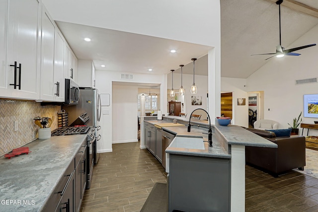 840 Tepic Dr, El Paso, TX 79912 - kitchen featuring appliances with stainless steel finishes, wood finish floors, open floor plan, a sink, and recessed lighting