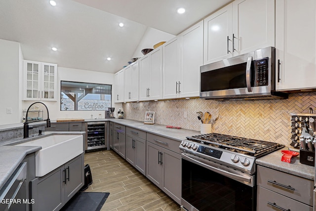 840 Tepic Dr, El Paso, TX 79912 - kitchen featuring stainless steel appliances, beverage cooler, a sink, gray cabinets, and tasteful backsplash