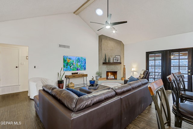 840 Tepic Dr, El Paso, TX 79912 - living area featuring high vaulted ceiling, a ceiling fan, dark wood finished floors, beam ceiling, and a large fireplace