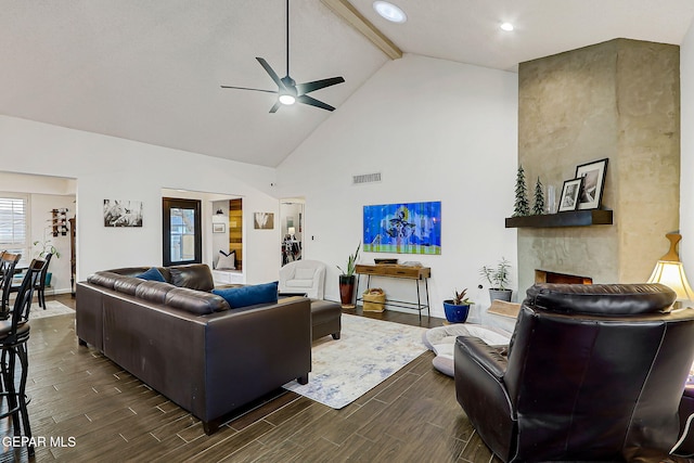 840 Tepic Dr, El Paso, TX 79912 - living room featuring a ceiling fan, wood tiled floors, high vaulted ceiling, beam ceiling, and a fireplace