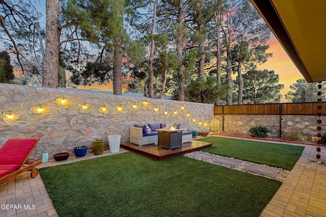 840 Tepic Dr, El Paso, TX 79912 - yard at dusk with a wooden deck and a fire pit