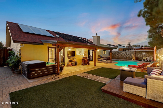 840 Tepic Dr, El Paso, TX 79912 - rear view of property featuring a hot tub, solar panels, a patio area, a chimney, and stucco siding