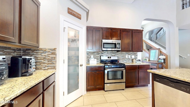 5712 Valley Lilac Ln, El Paso, TX 79932 - kitchen featuring appliances with stainless steel finishes, backsplash, and light stone counters