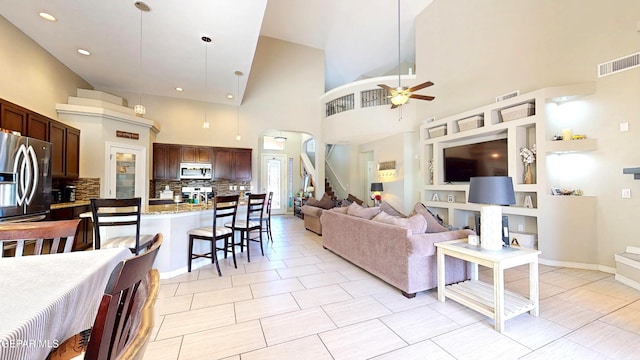 5712 Valley Lilac Ln, El Paso, TX 79932 - living room featuring ceiling fan, high vaulted ceiling, stairs, and recessed lighting