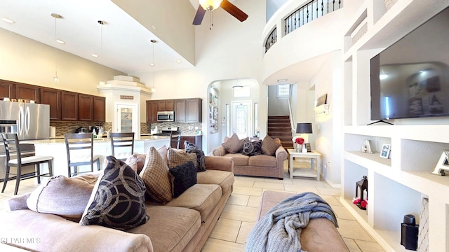5712 Valley Lilac Ln, El Paso, TX 79932 - living room with built in features, a ceiling fan, a high ceiling, stairs, and recessed lighting