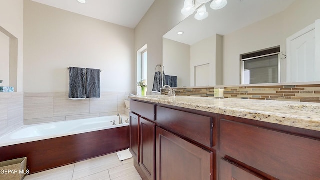 5712 Valley Lilac Ln, El Paso, TX 79932 - full bathroom with vanity, a garden tub, and backsplash