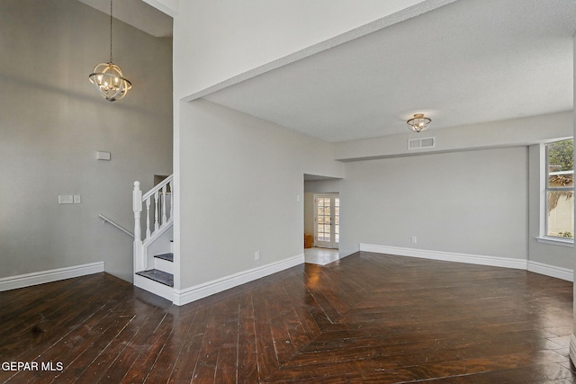 1718 Dean Jones Dr, El Paso, TX 79936 - spare room featuring stairway, a chandelier, baseboards, and wood finished floors