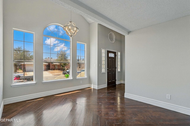 1718 Dean Jones Dr, El Paso, TX 79936 - foyer entrance featuring a chandelier, a textured ceiling, plenty of natural light, baseboards, and wood finished floors