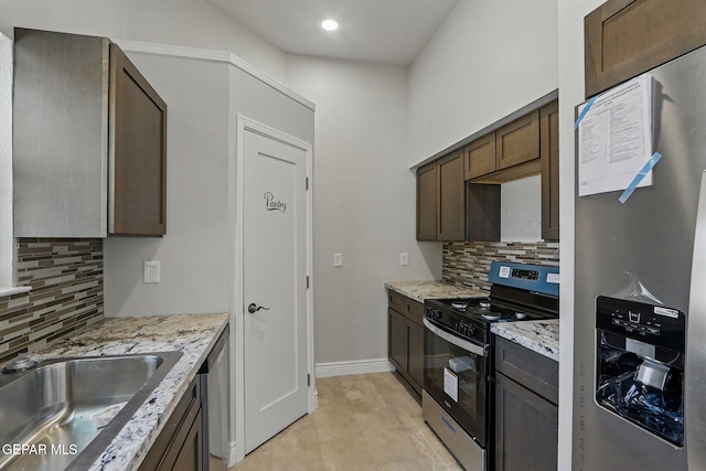 1718 Dean Jones Dr, El Paso, TX 79936 - kitchen with electric range oven, stainless steel fridge with ice dispenser, decorative backsplash, light stone countertops, and recessed lighting