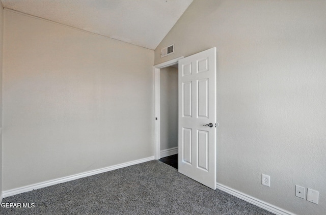 1718 Dean Jones Dr, El Paso, TX 79936 - spare room with vaulted ceiling, dark carpet, and baseboards