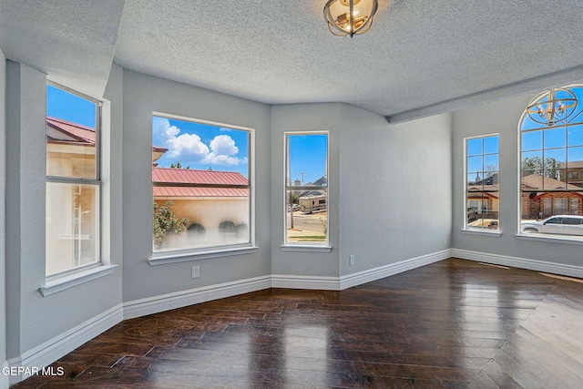 1718 Dean Jones Dr, El Paso, TX 79936 - unfurnished room with wood-type flooring, a textured ceiling, and baseboards