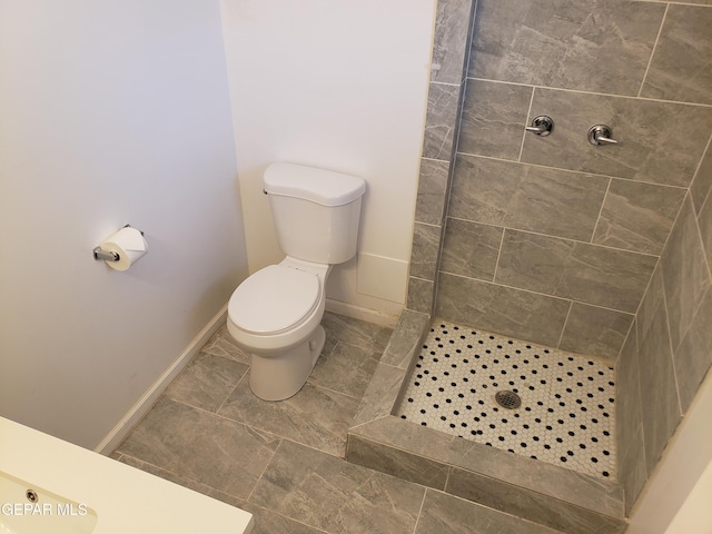 10173 Lakeview Dr, El Paso, TX 79924 - full bath with a tile shower, toilet, and baseboards