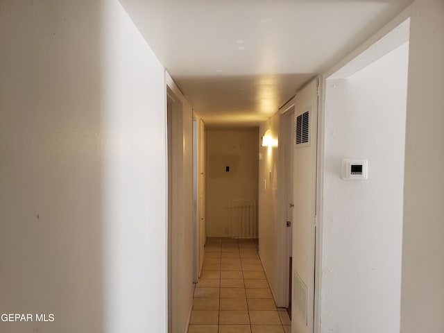 10173 Lakeview Dr, El Paso, TX 79924 - corridor featuring light tile patterned floors and radiator